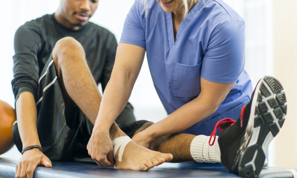 Physical Therapy An athlete receiving rehibilitative care for a sports injury.