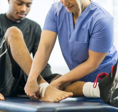 An athlete receiving rehibilitative care for a sports injury.