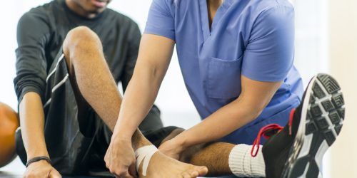 Physical Therapy An athlete receiving rehibilitative care for a sports injury.