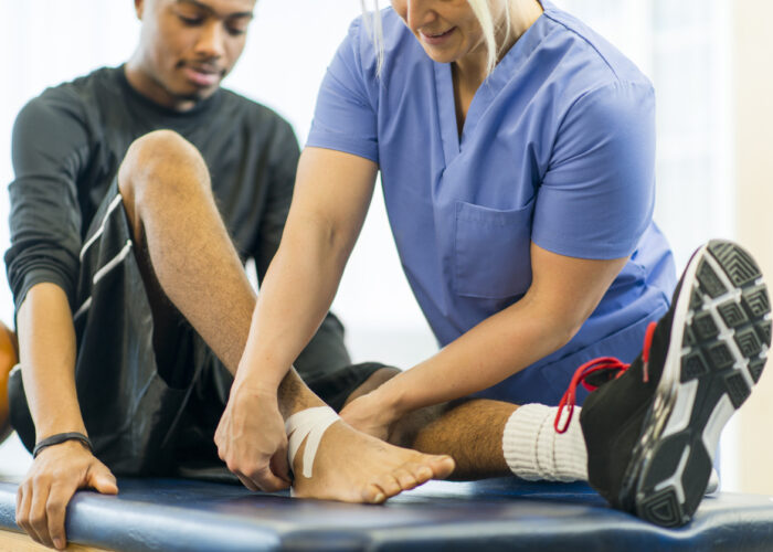 Physical Therapy An athlete receiving rehibilitative care for a sports injury.